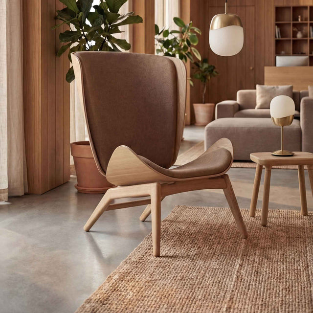UMAGE_lifestyle_The Reader_oak_sugar brown_Paff_travertine_oak_Spring_pendant lampshade_medium_large_brass_Spring_table lamp_brass.jpeg